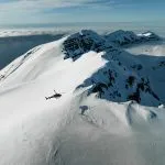 helicopter over snowy mountains