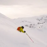 skier carving snowy mountain slope
