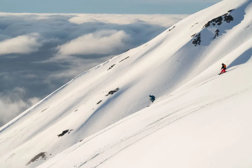 skiers carving on mountain slope