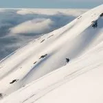 skiers carving on mountain slope