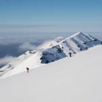 skiers on snowy mountain slope