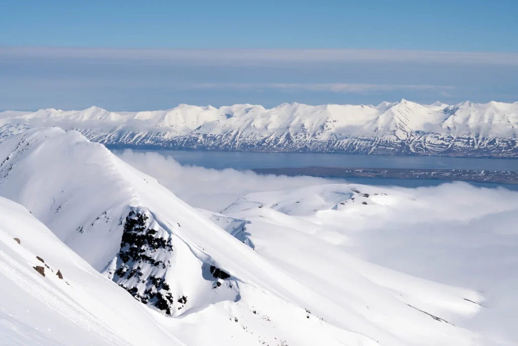 snowy mountain peaks above clouds
