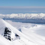 snowy mountain peaks above clouds