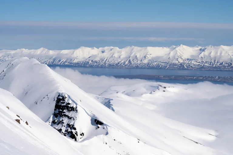 snowy mountain peaks above clouds
